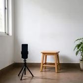 Phone on a tripod facing a plain white wall